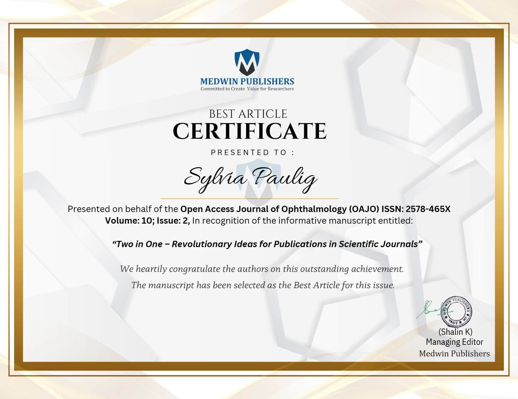 شهادة بيضاء عليها نص بالانجليزية مع ختم ذهبي وتوقيع محرر المجلة